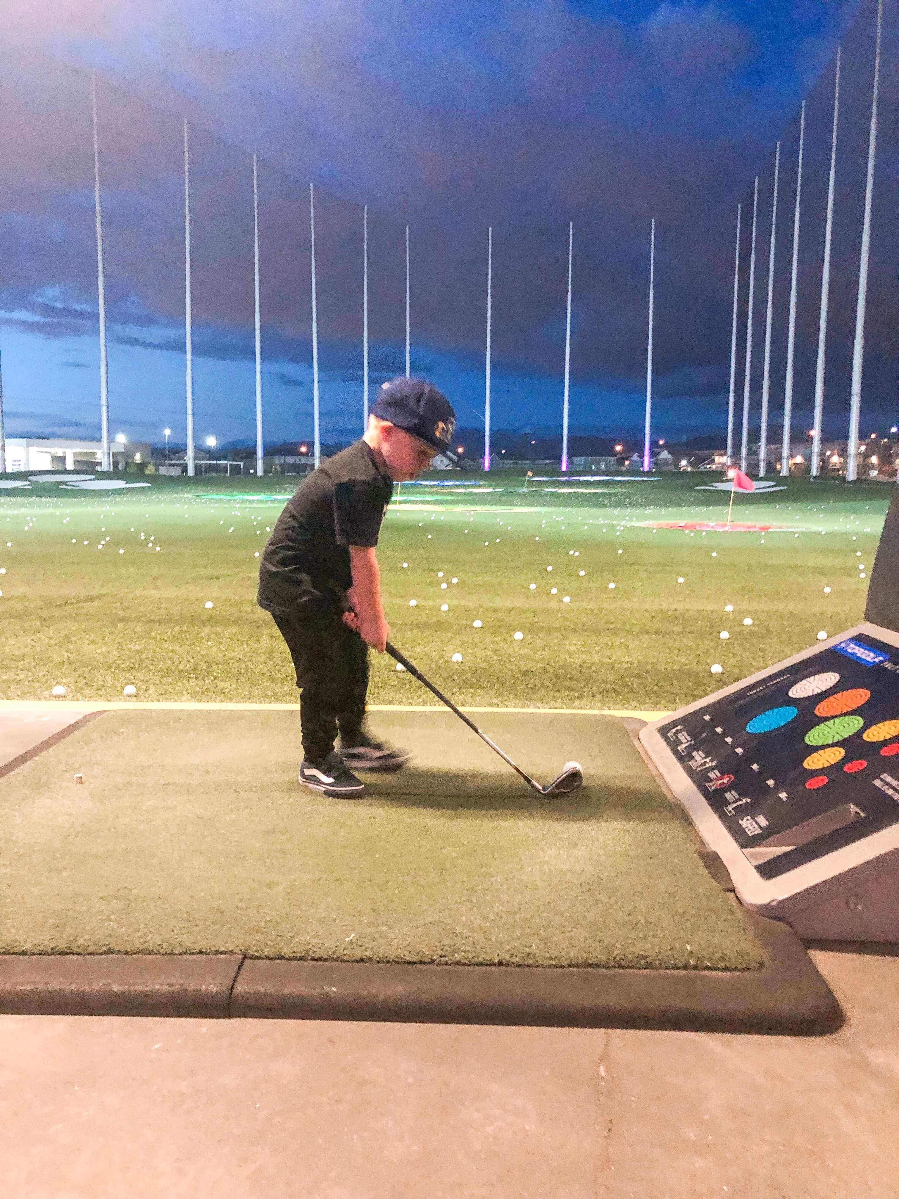 Toddler Playing golf at Topgolf