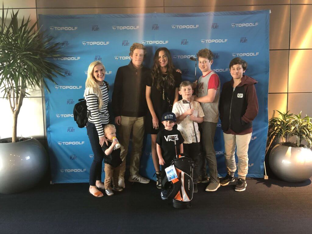 Family posing for picture at Topgolf